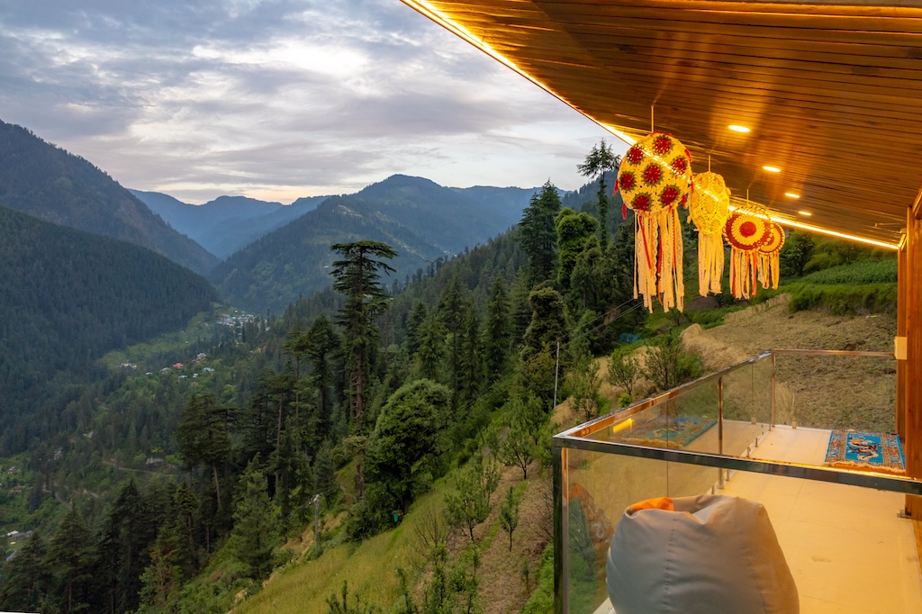 Outdoor deck terrace with lounge chairs facing a valley